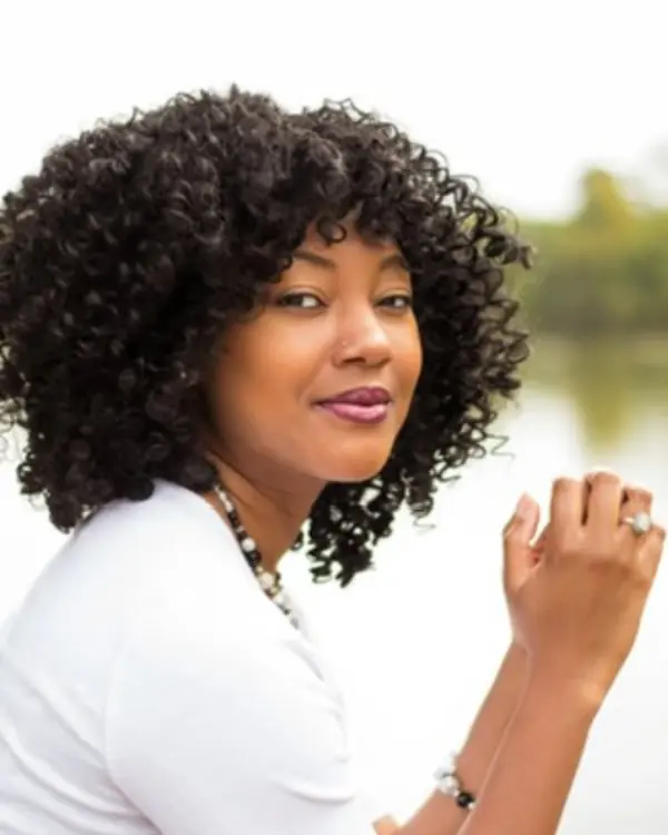 Cherelle Williams Espinoza seated outdoors by a lake